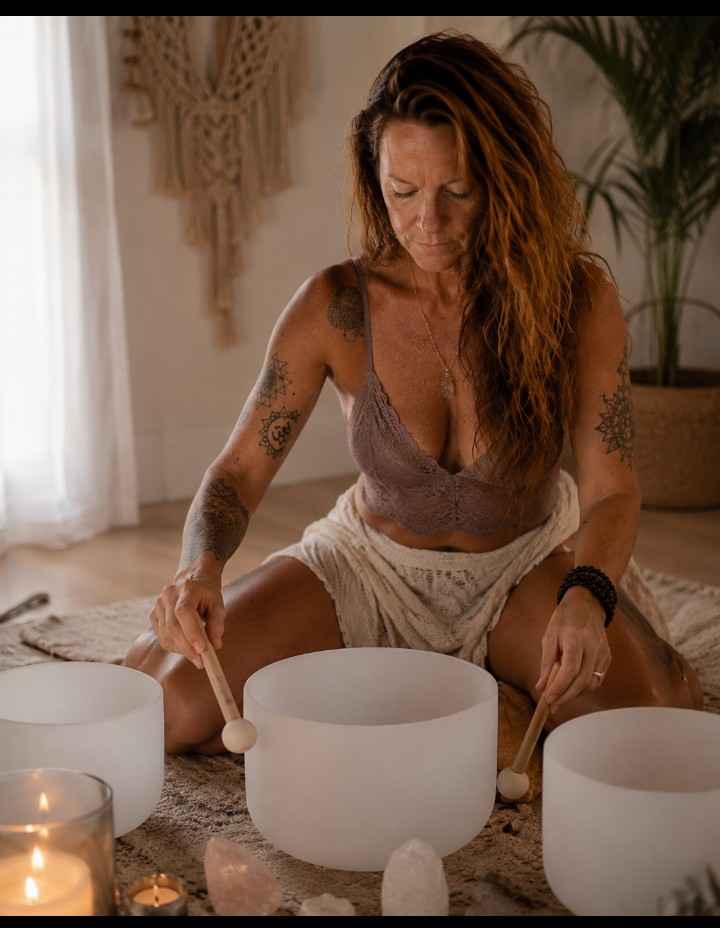 Playing crystal sound bowls by candlelight